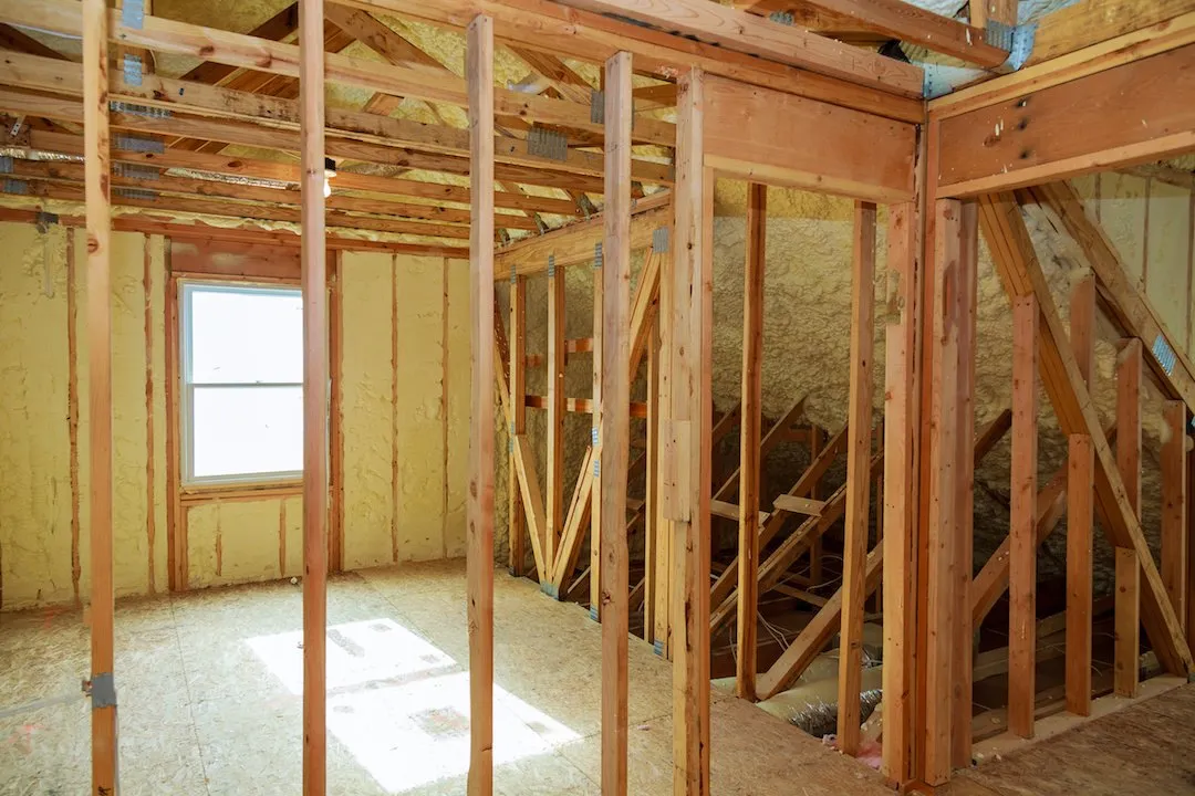 Fiberglass wall insulation in a framed assembly